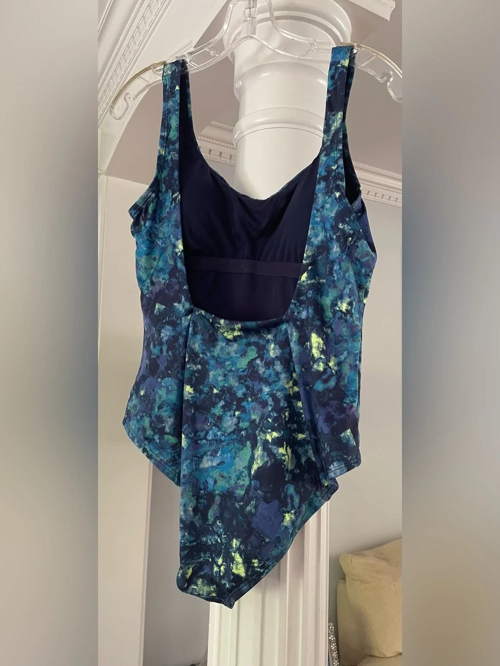 Nike women’s one piece swimsuit abstract watercolors print with a swoosh logo .